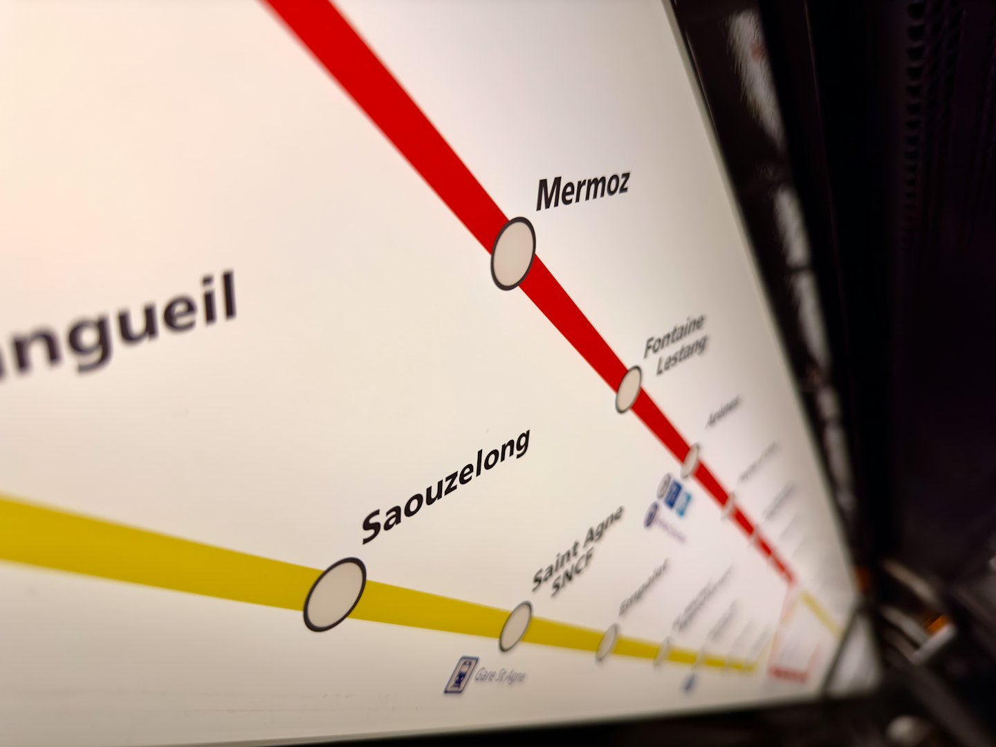 Brightly lit transit map displaying red and yellow routes.